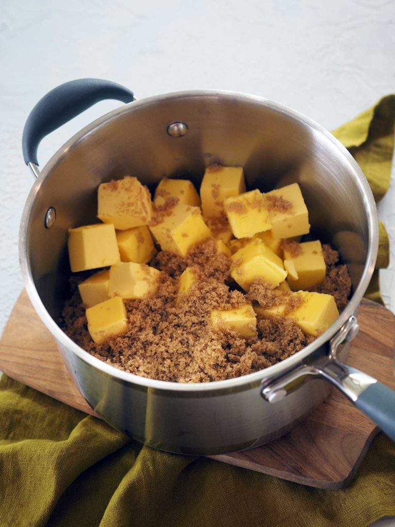 Large dices of butter and brown sugar in a saucepan.