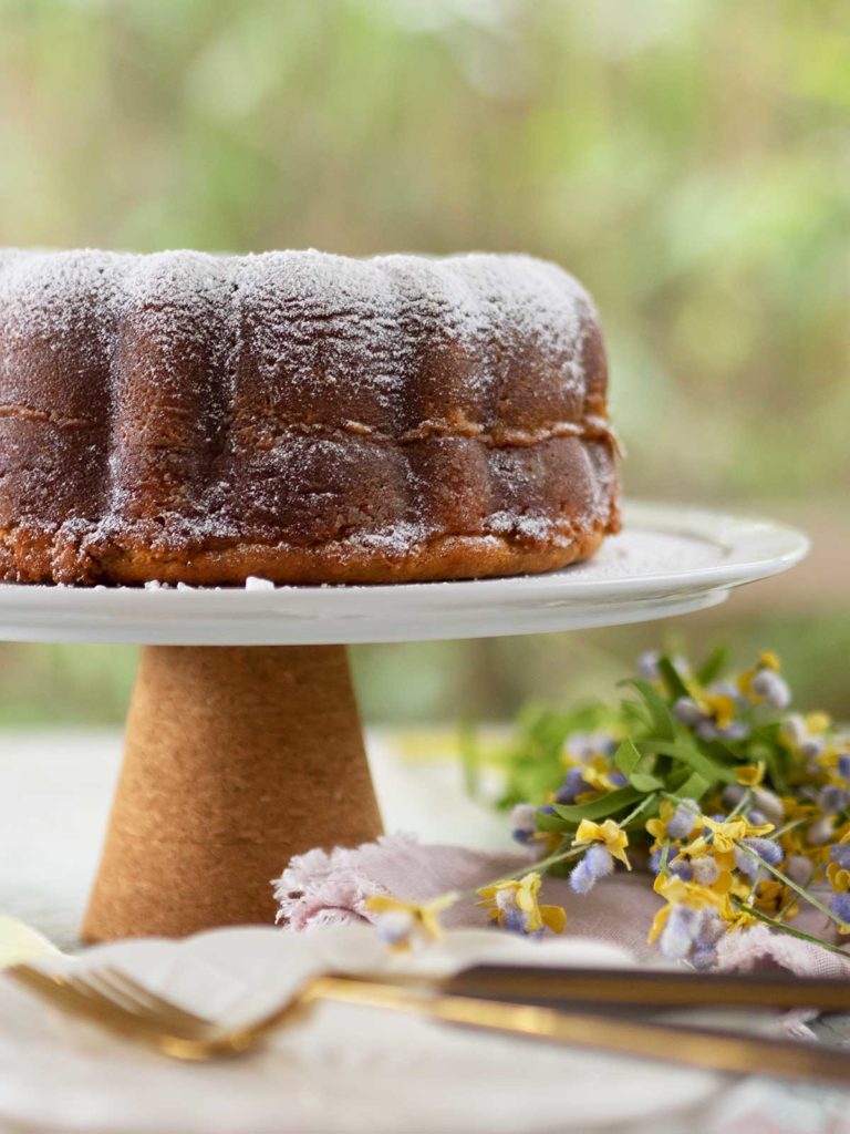 crack cake dusted with sugar snow on a cake stand