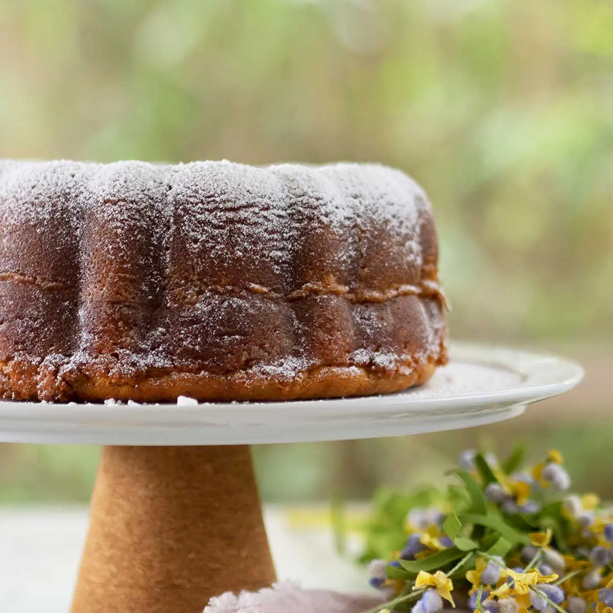 crack cake decorated with sugar snow on a cake stand