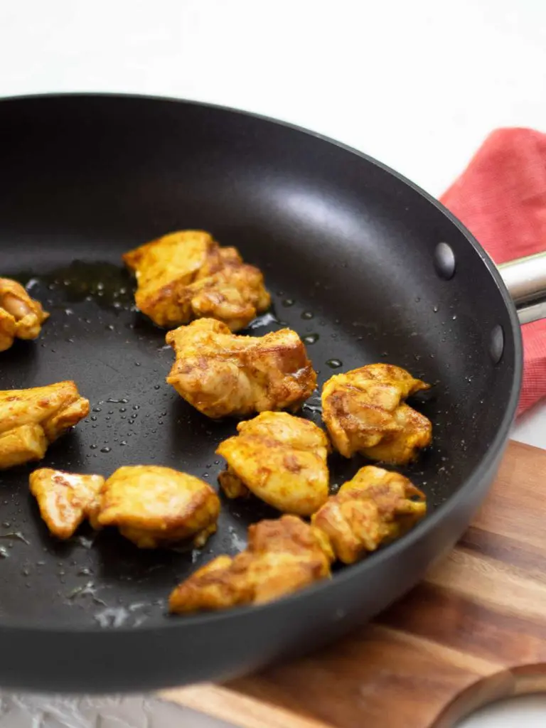 browning chicken in a fry pan