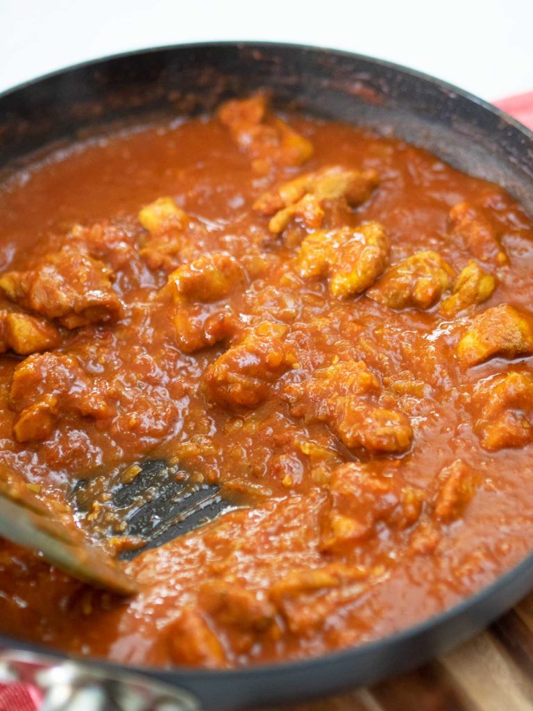 curry in a pan showing the thickening stage