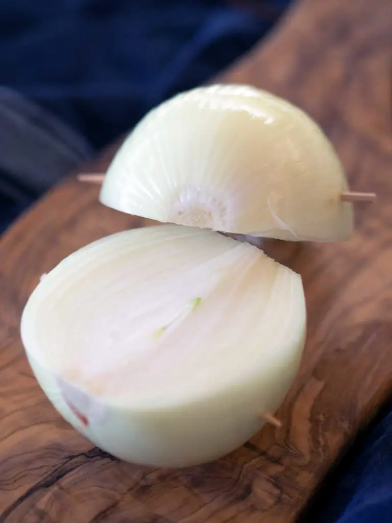 onion skinned, cut in half with toothpicks to hold it together