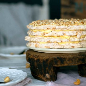 sans rival filippino cashew meringue cake on a wooden stand