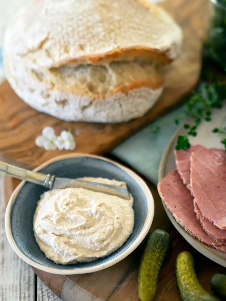 walnut sauce in a bowl, sourdough and corned beef on a board