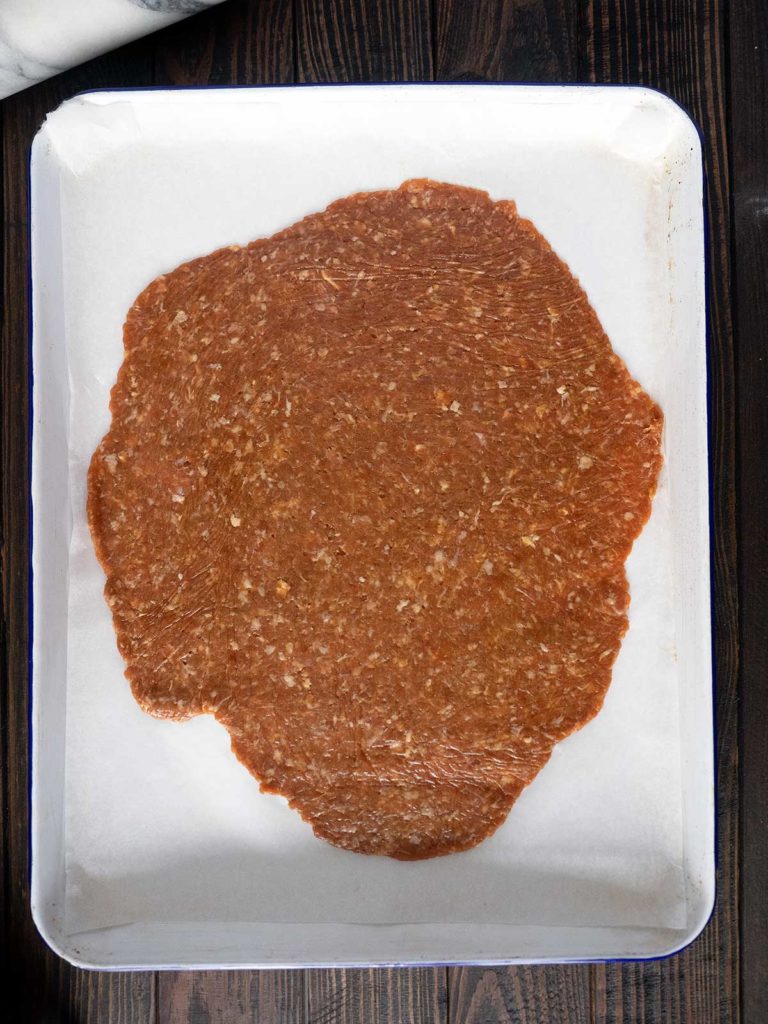 rolled out bakkwa on a baking sheet
