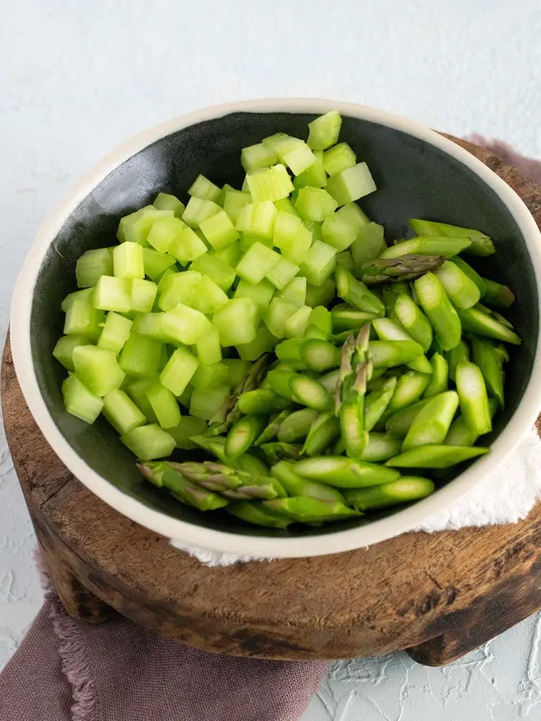 diced asparagus and celery in a black bowl