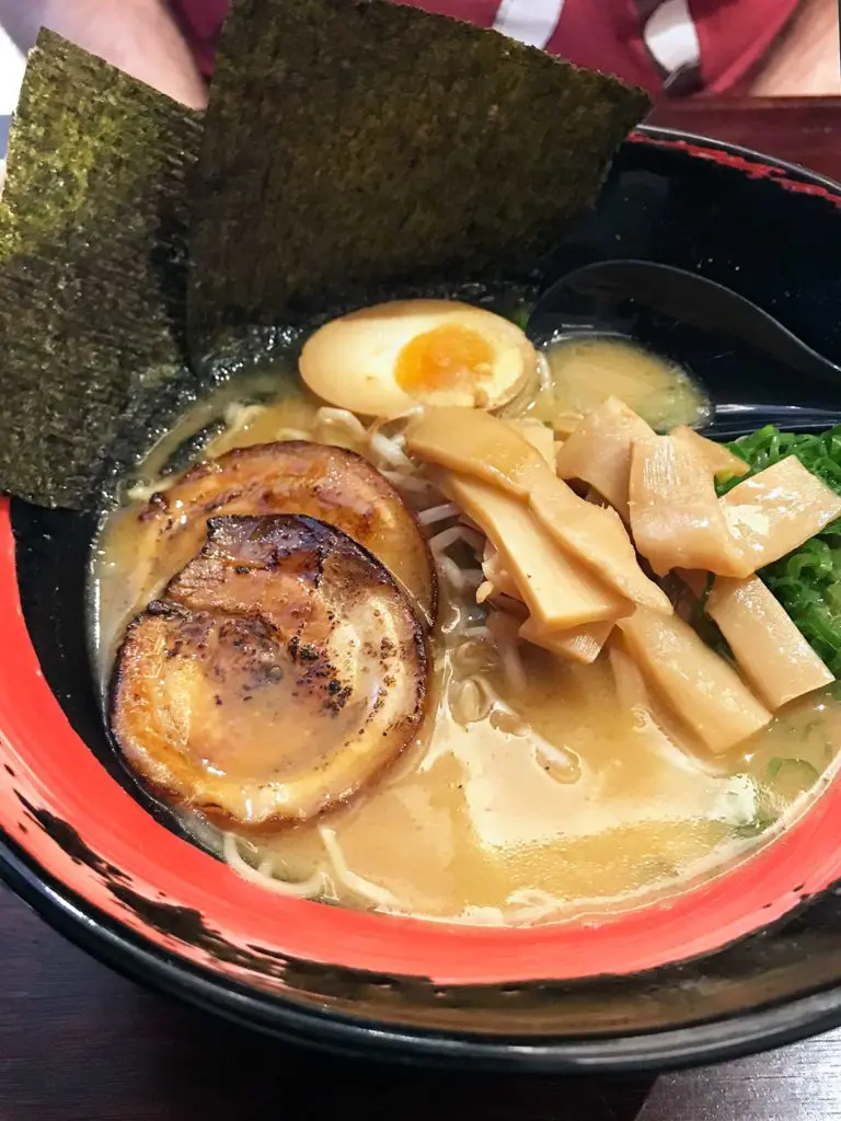 a bowl of pork ramen with slices of chashu on top