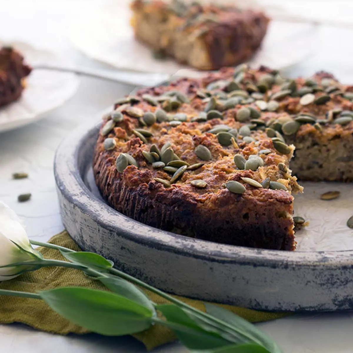 Apple almond cake missing 2 slices on top of a stone plate