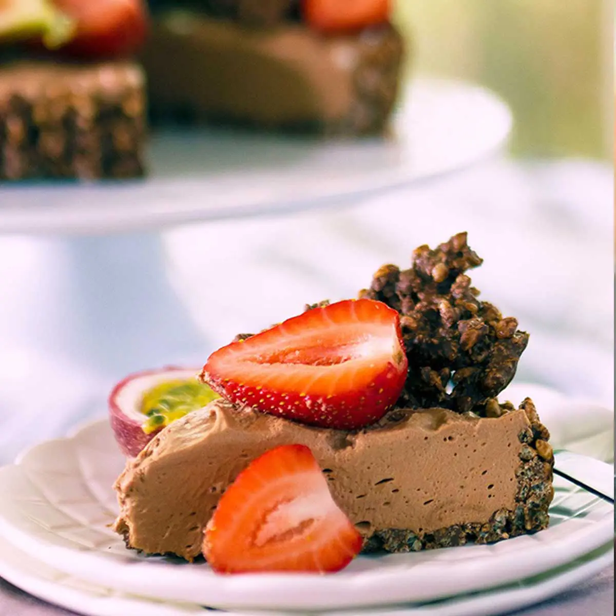 A slice of chocolate cheesecake pie topped with fresh strawberry.