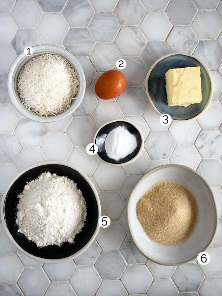 coconut biscuit ingredients laid out on white tiles