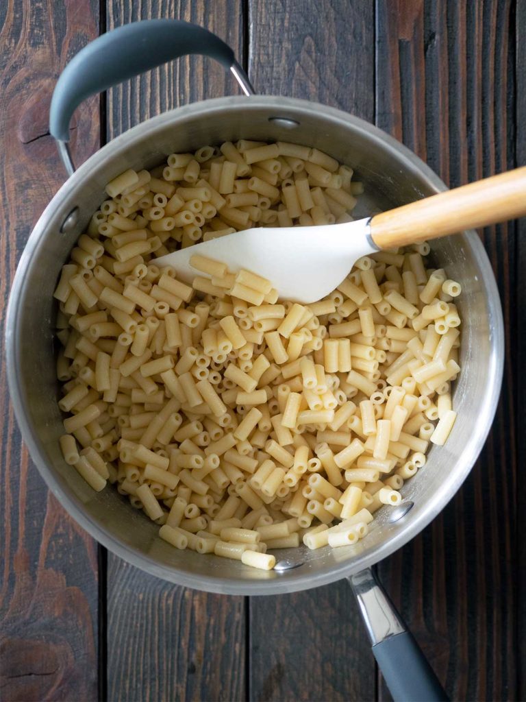 vinegar being mixed through macaroni