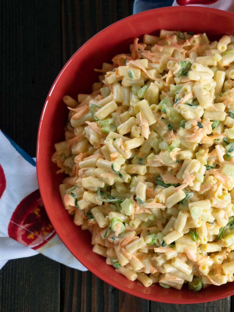 creamy pasta salad in a red bowl