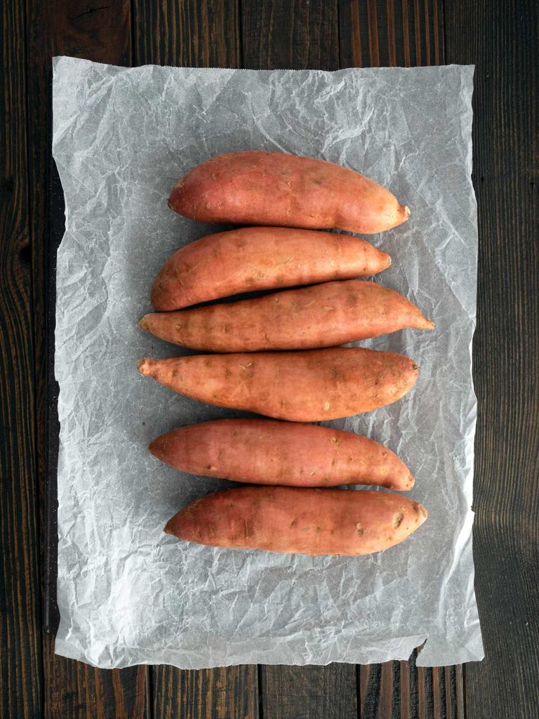 potatoes on a baking tray ready to go into the oven