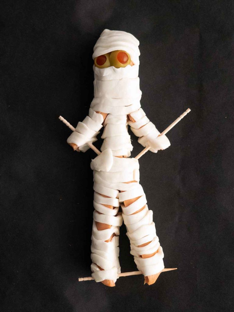 hot dog mummy with arms and legs secured by toothpicks