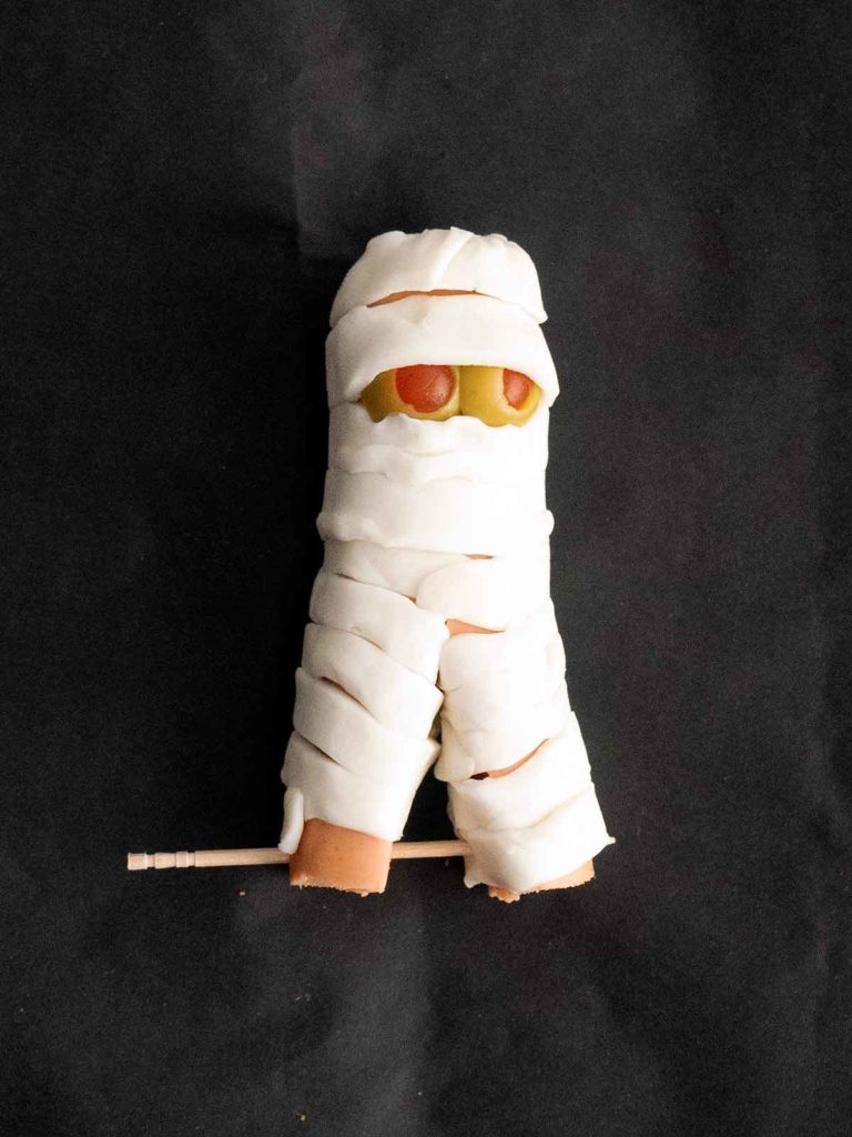 mini hot dog mummy with legs secured by toothpicks
