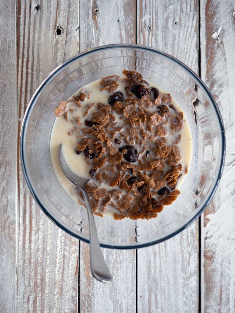 bran and raisins in a bowl after soaking in milk for a while