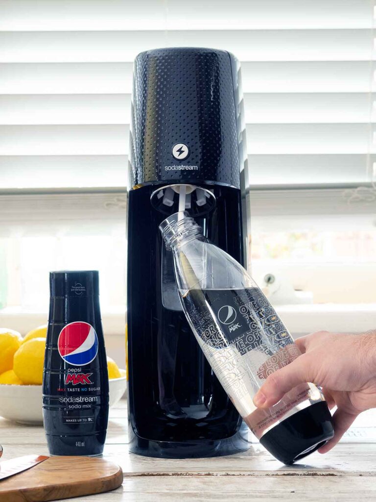 inserting a bottle of water into sodastream machine