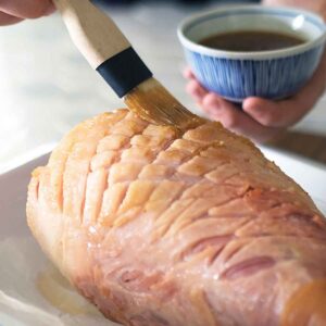 brushing glaze on a ham