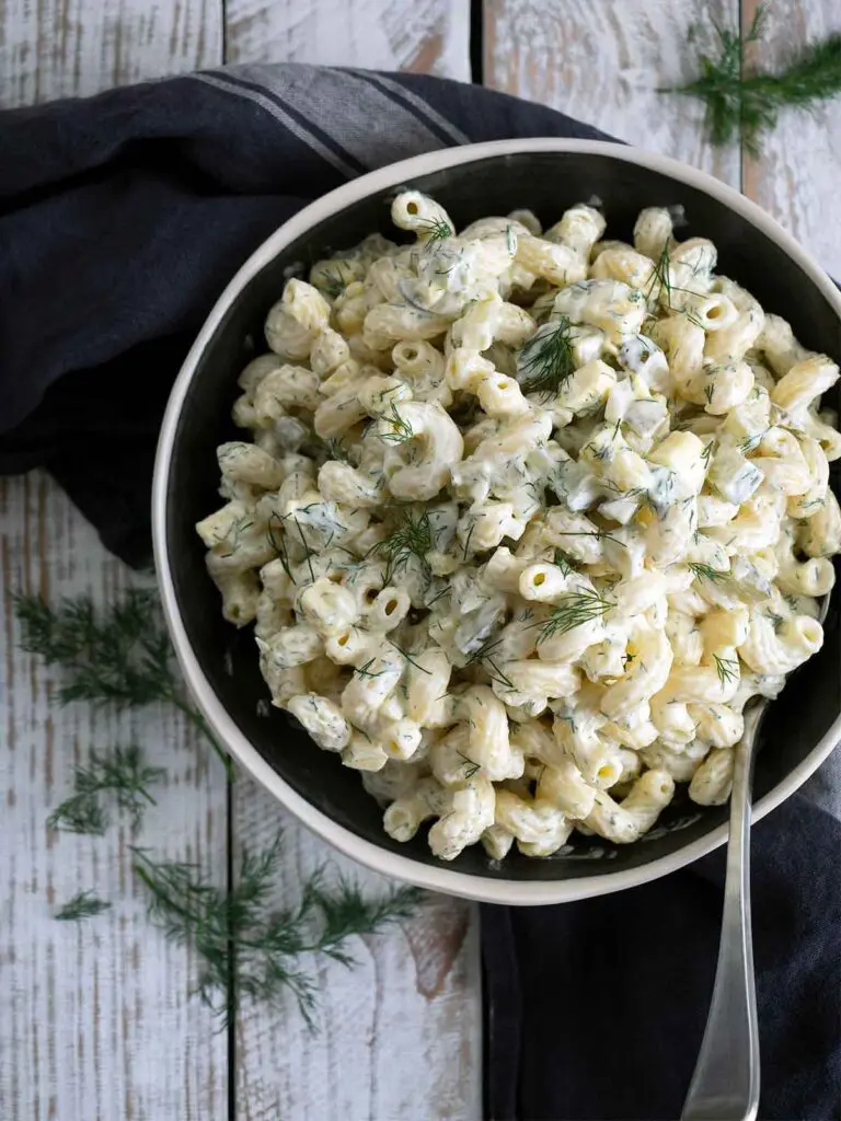dill pickle pasta salad in a serving bowl with a spoon