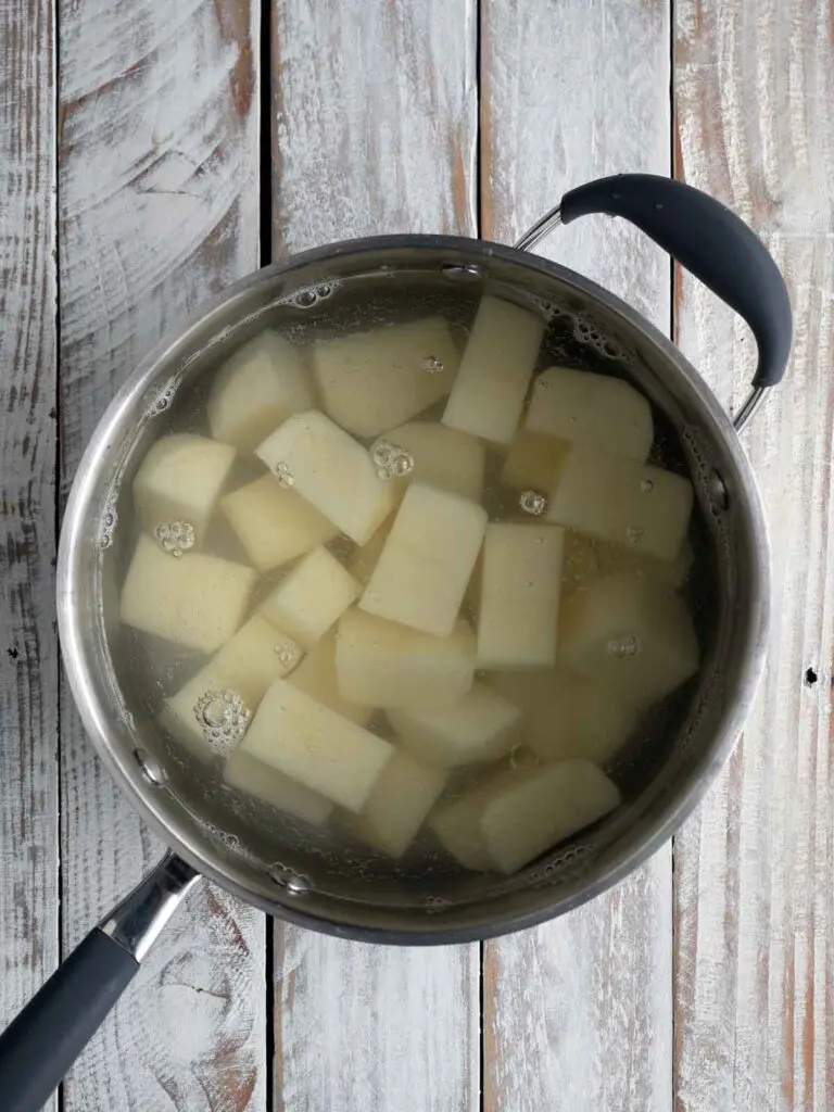 potatoes cut up in a pot ready to boil