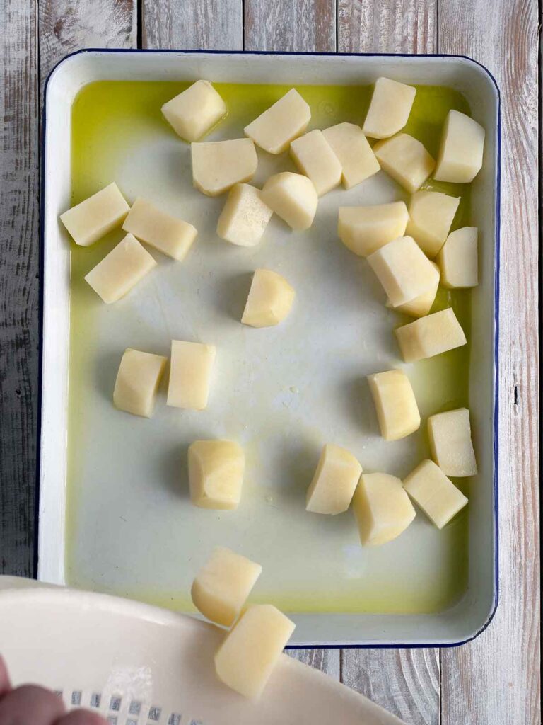 potatoes in a baking tray ready for the oven