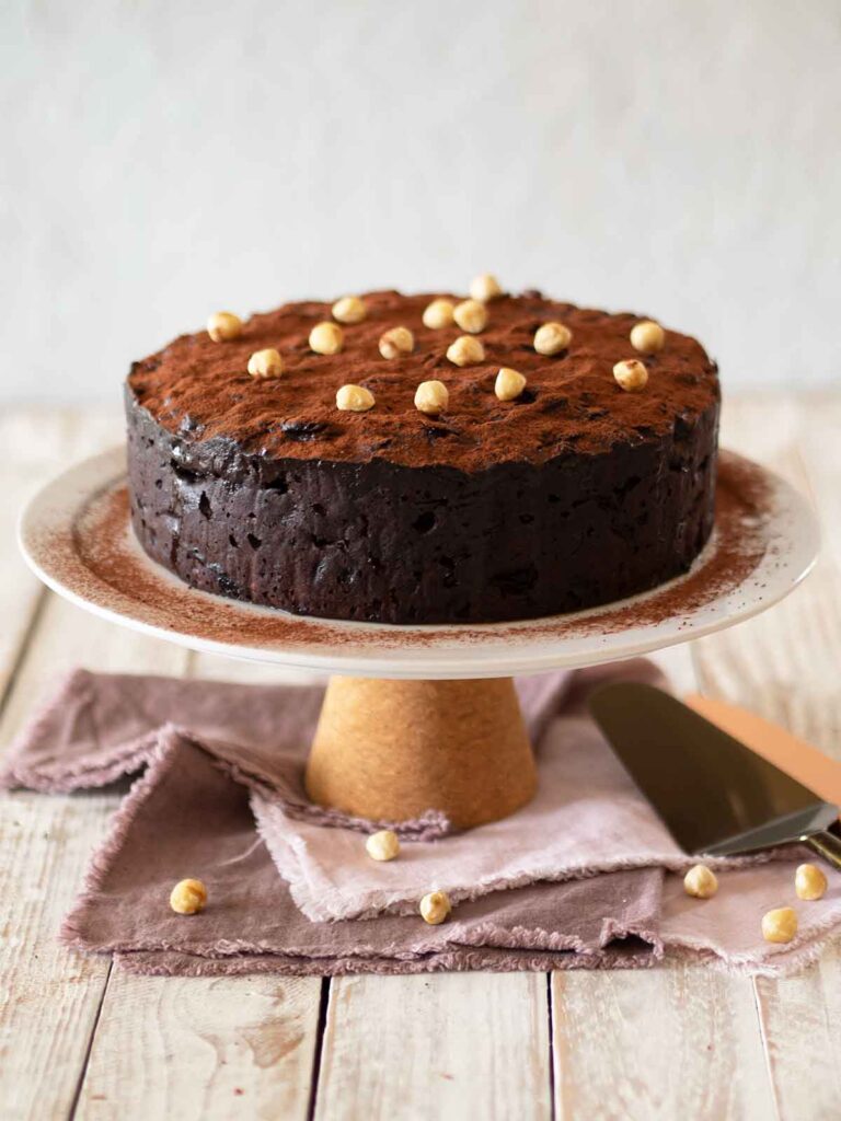 decorated hazelnut chocolate fruit cake on cake stand ready to serve