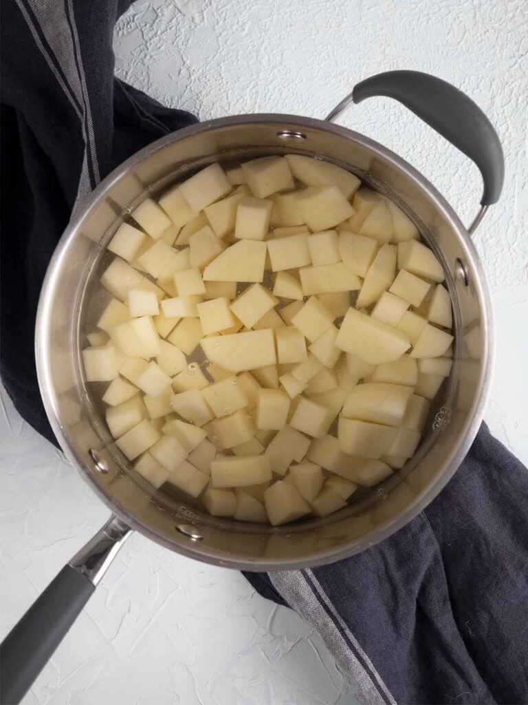 potatoes boiling in a pot of water