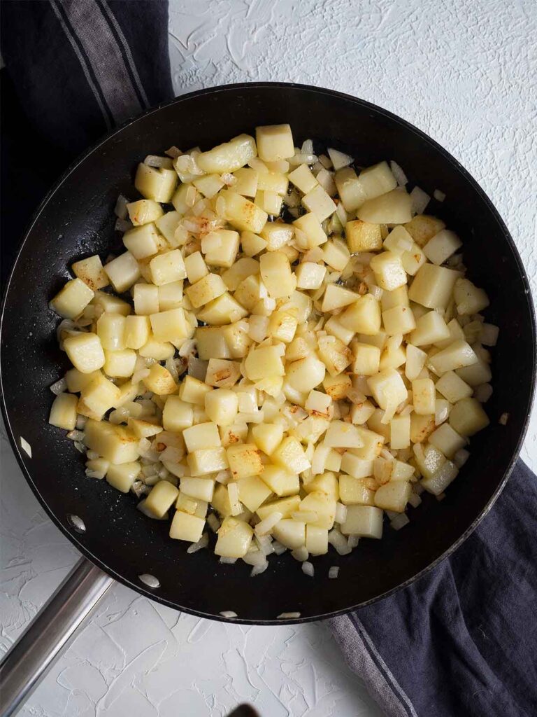 potatoes and onions in a fry pan