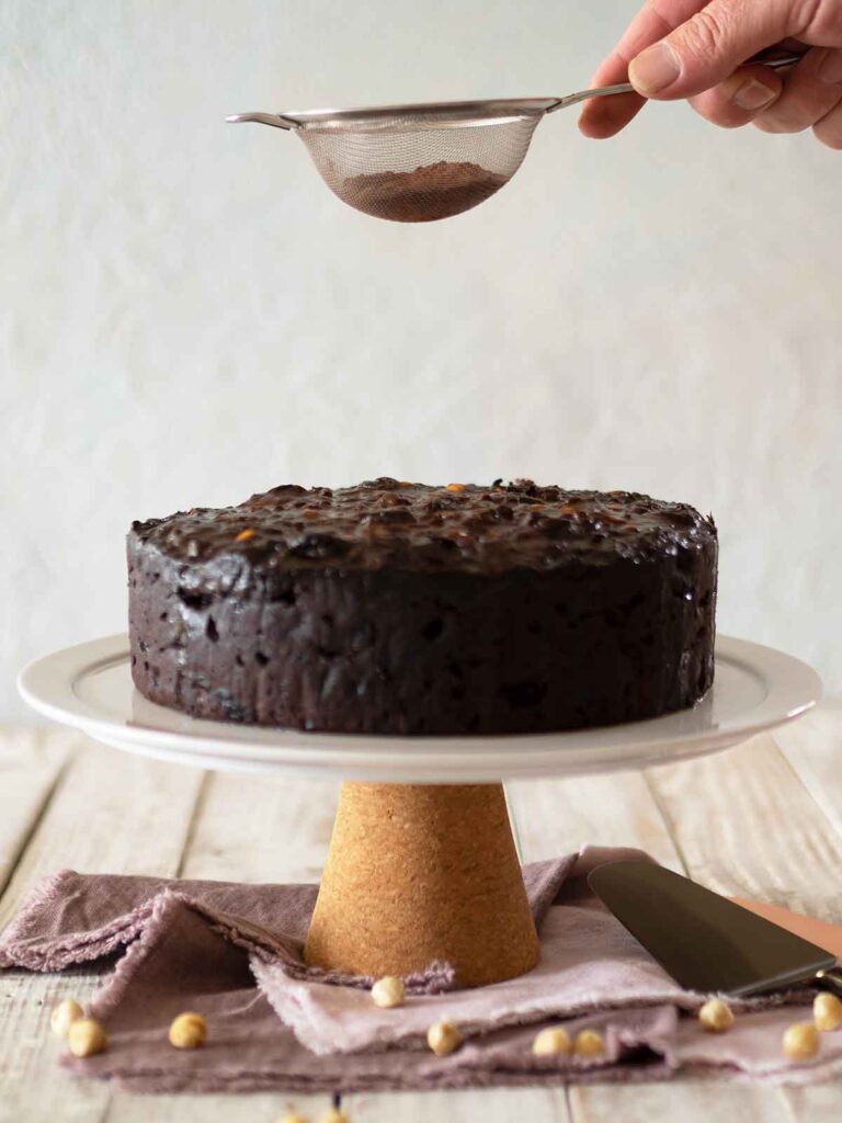 dusting cake with cocoa powder