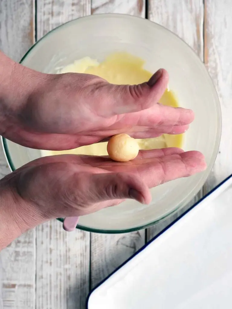 process image of hands rolling balls of mixture