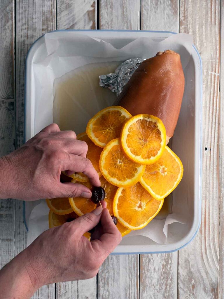 placing cherries on top of orange slices