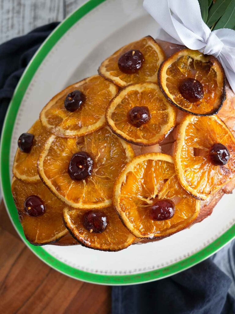 old fashioned glazed ham decorated and on serving platter