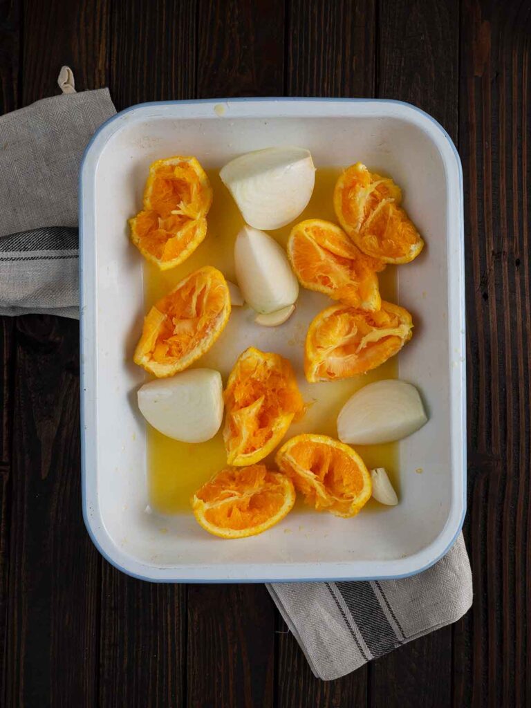 oranges and onions in roasting pan