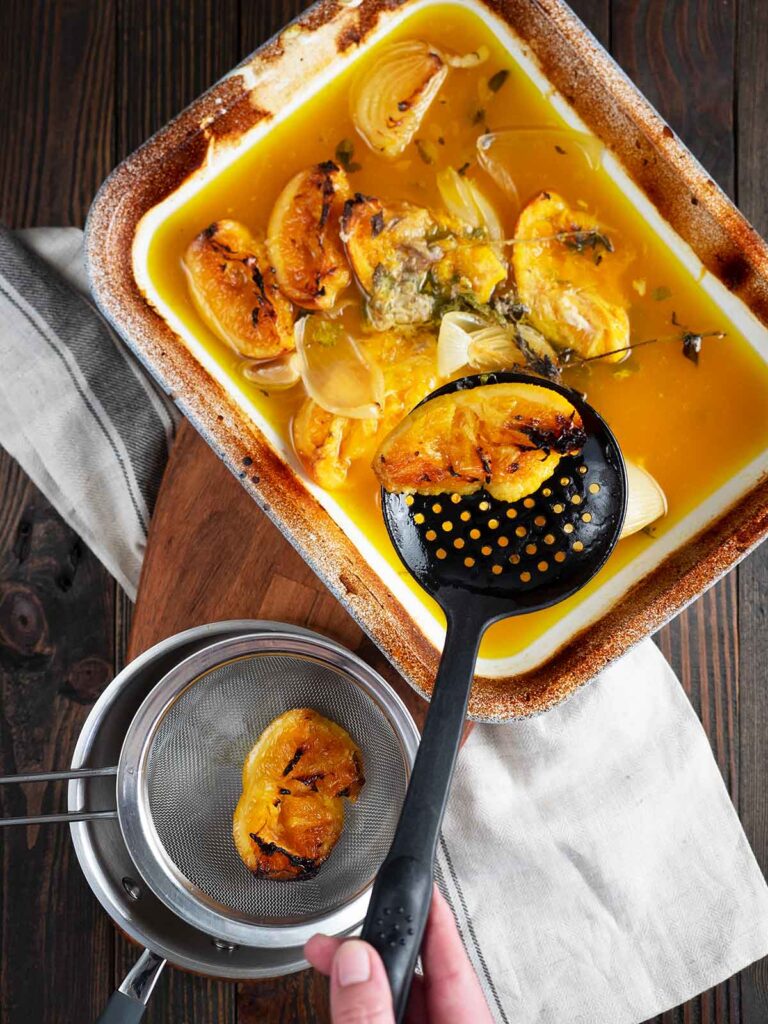 removing aromatics from the roasting pan to create the gravy