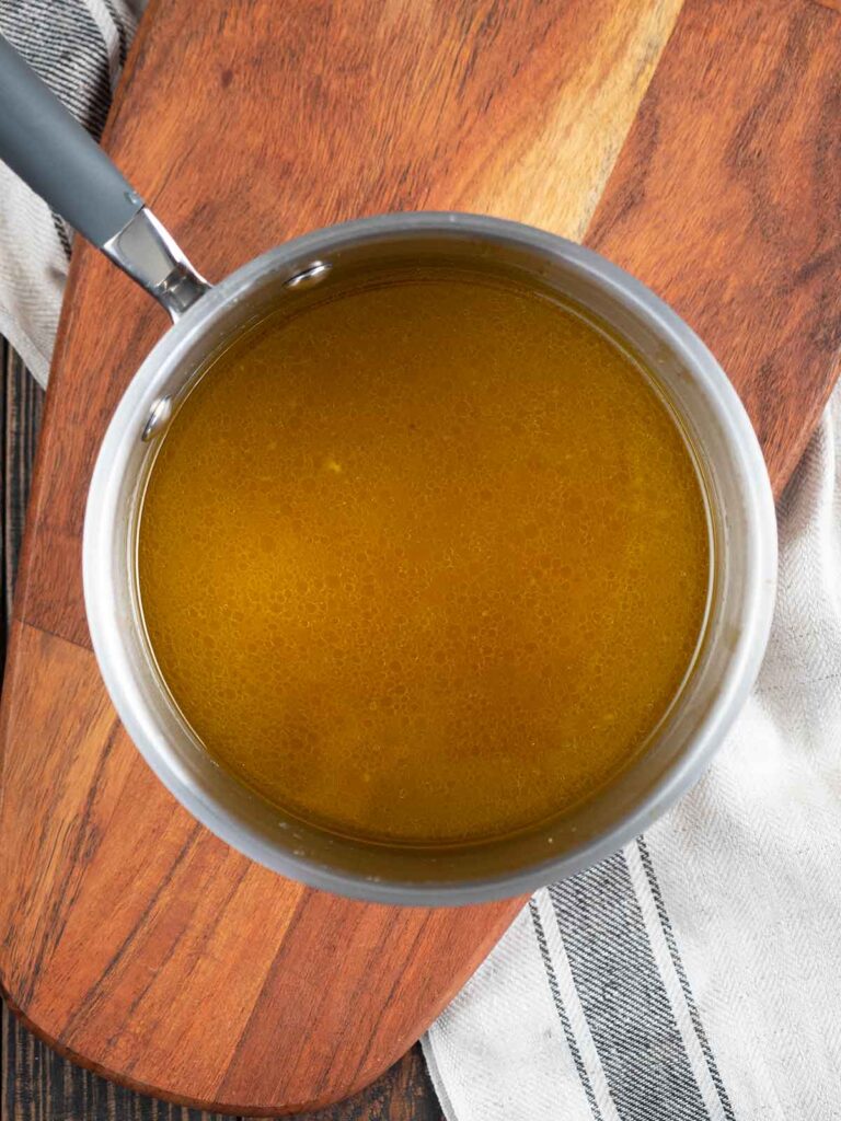 pan juices in a sauce pan ready to be reduced