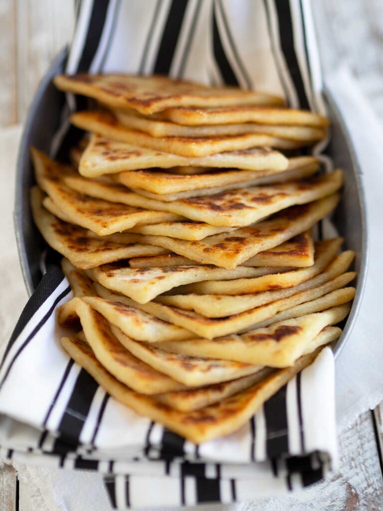 Irish potato bread in a basket with black and white striped cloth