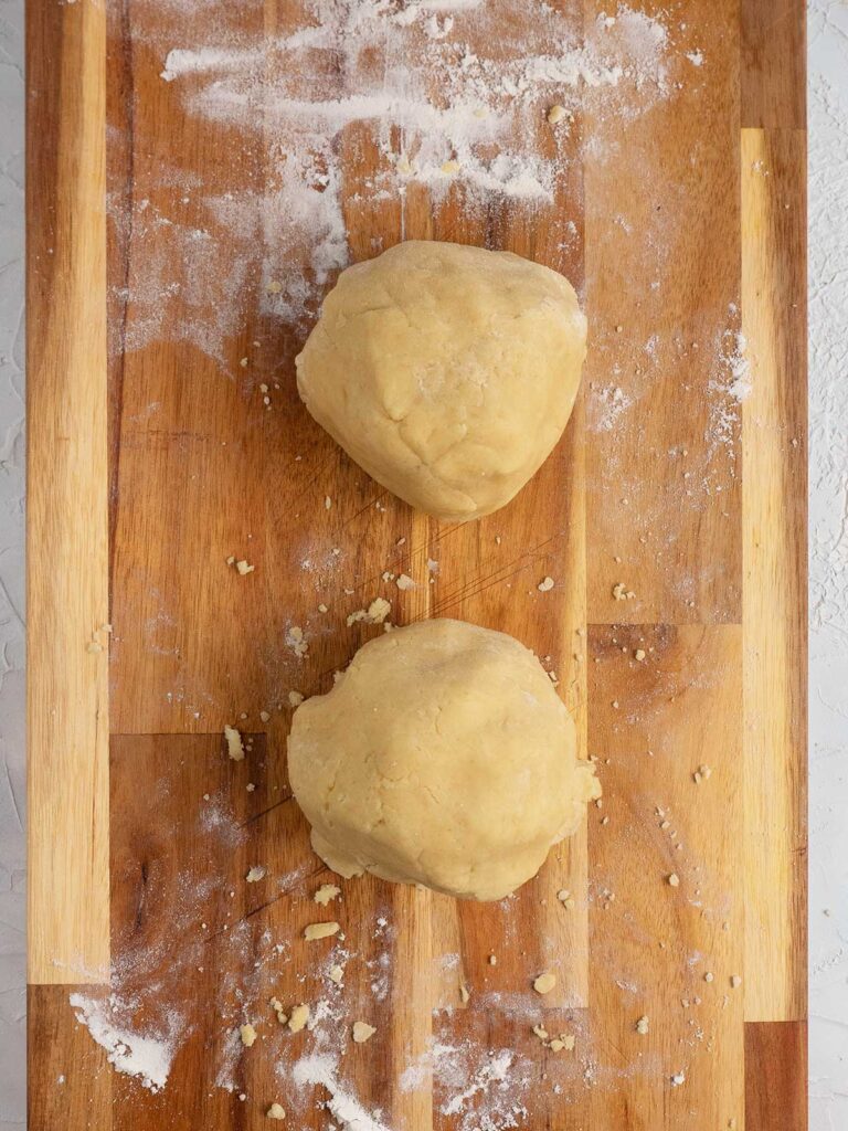 two balls of dough on a wooden board