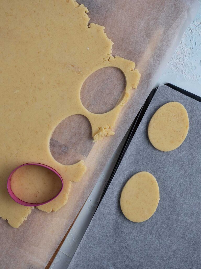 cutting egg shaped cookies from cookie dough
