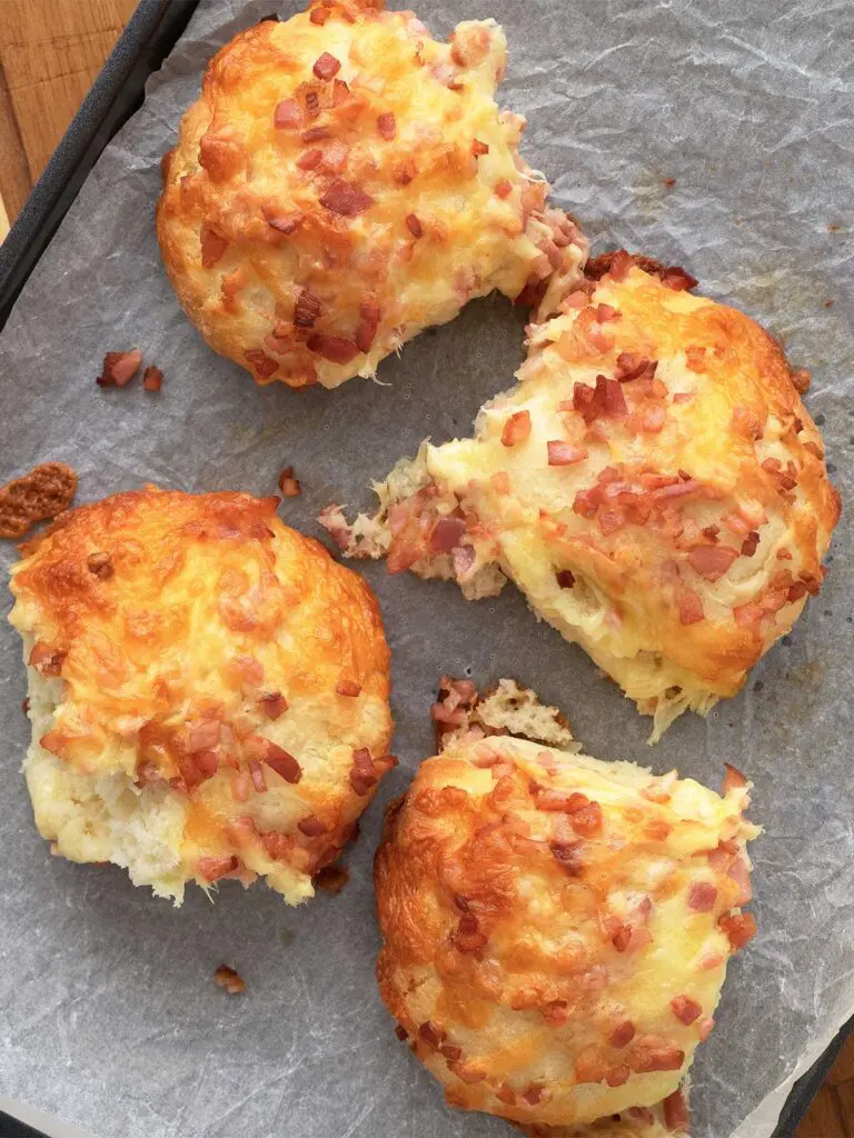 cheese and bacon rolls on a baking sheet