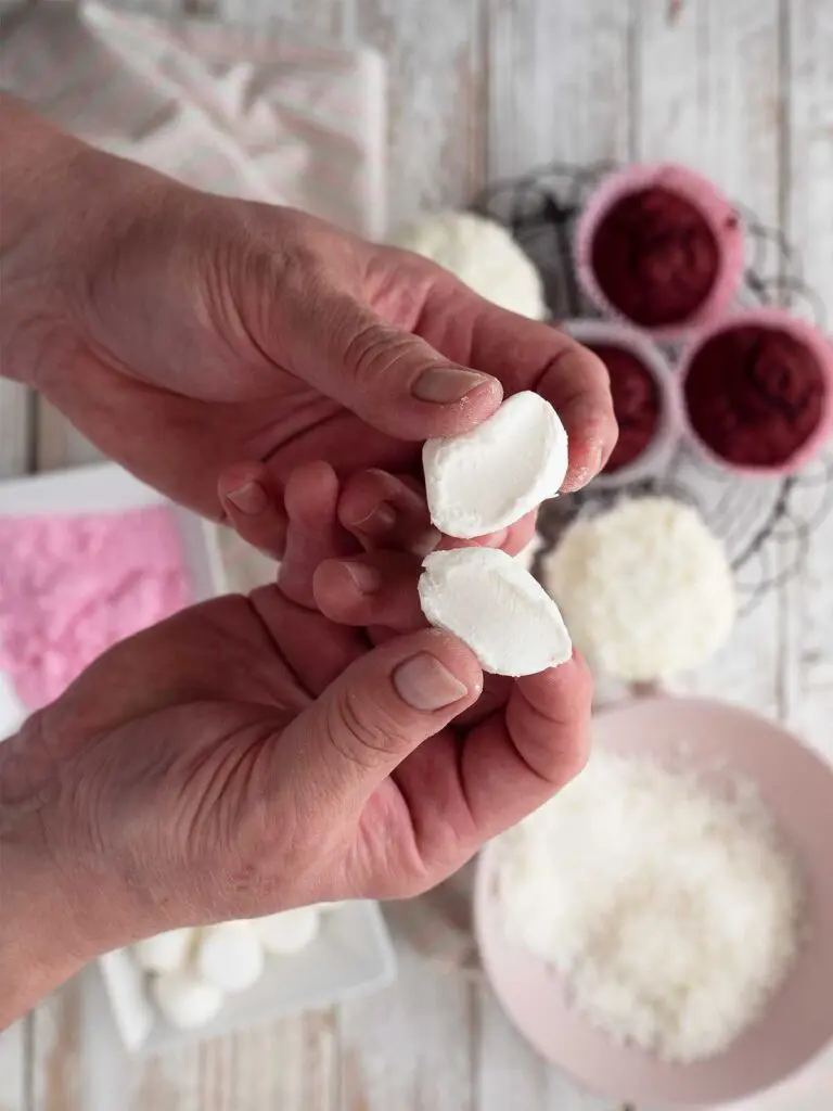 two halves of a marshmallow being held