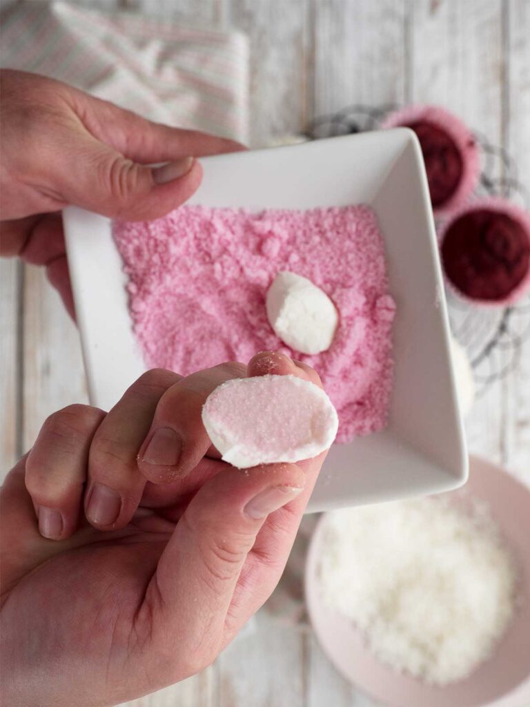 dipping cut marshmallows in pink sanding sugar