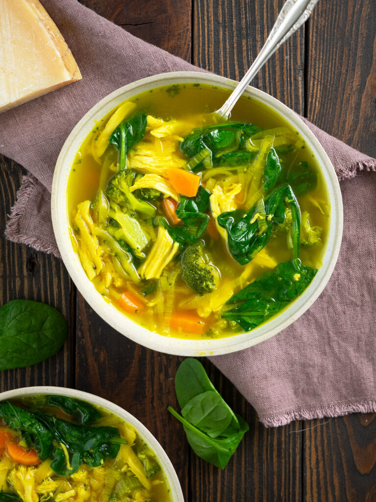 top view of chicken ginger soup in a bowl with spoon