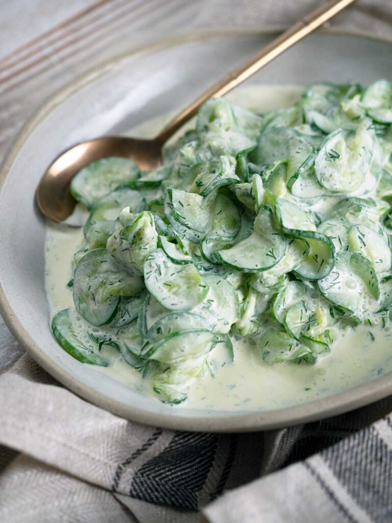 cucumbers with sour cream in a serving bowl