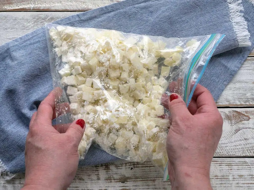 tossing cooked diced potato in cornstarch in a plastic zip lock bag