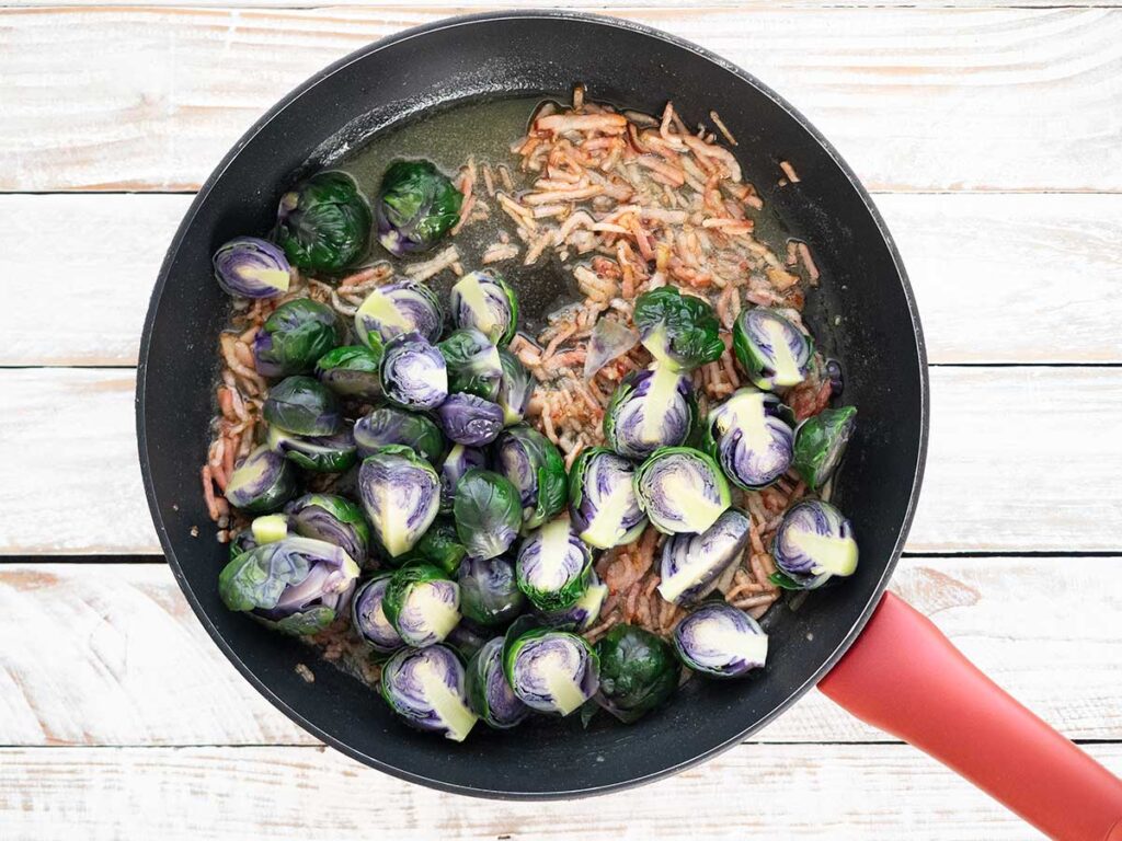adding sprouts to the fry pan