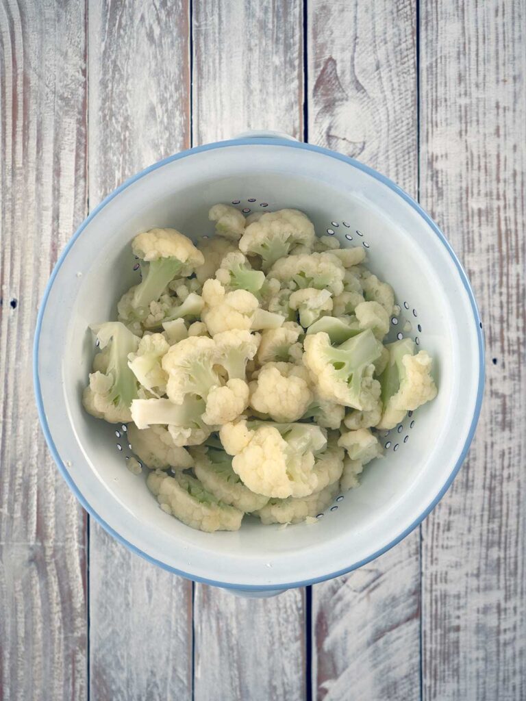 blanched strained cauliflower in a colander