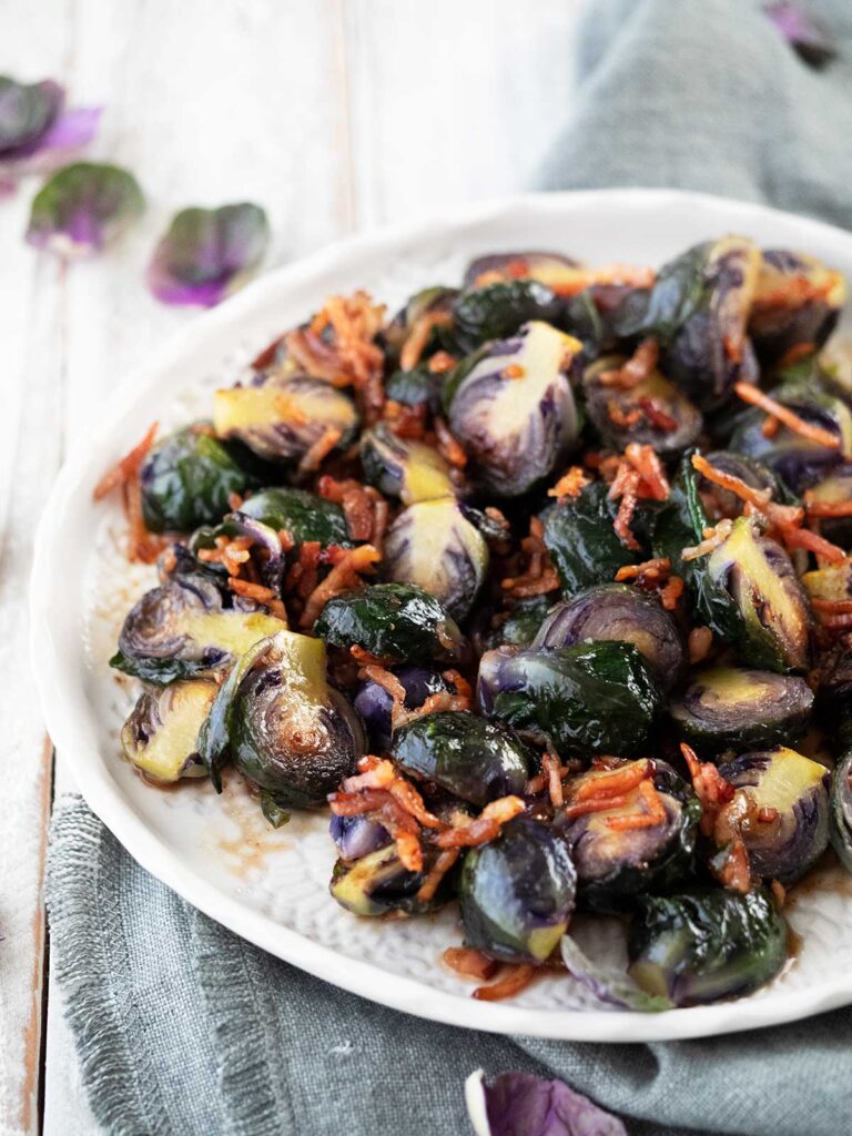 maple bacon brussels sprouts on a white serving plate