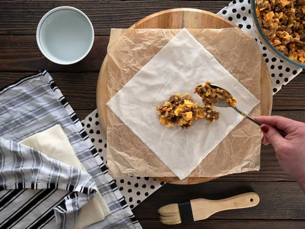 placing the cheeseburger filling in the middle of the spring roll