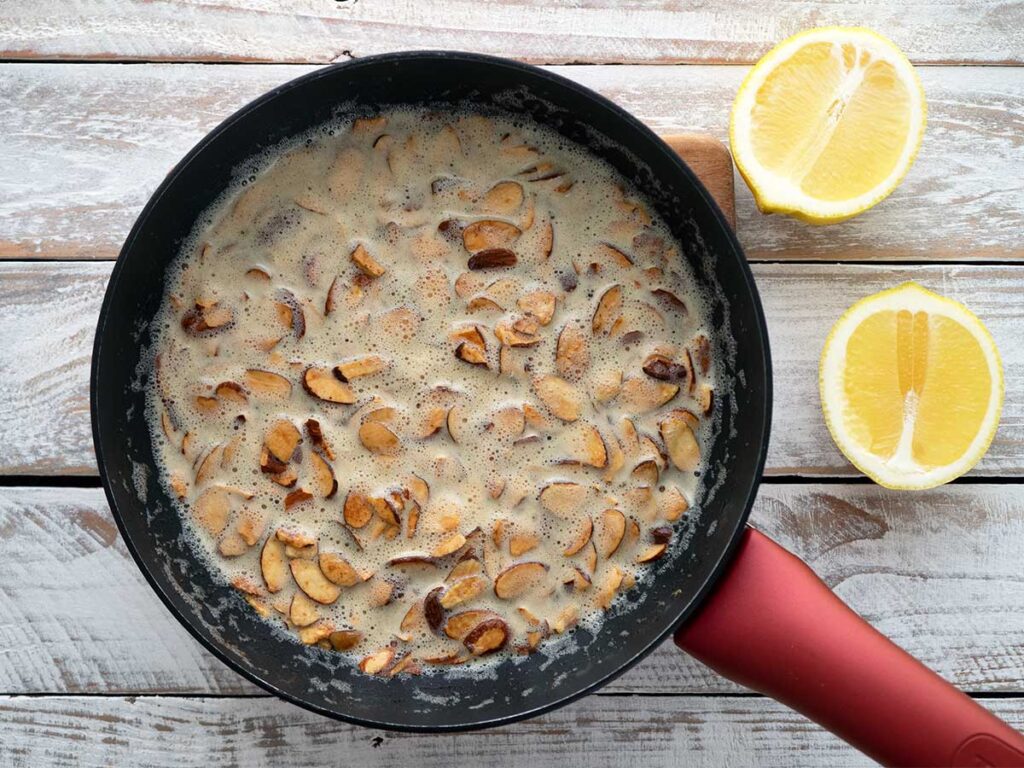 deeply roasted almonds and butter in a frying pan