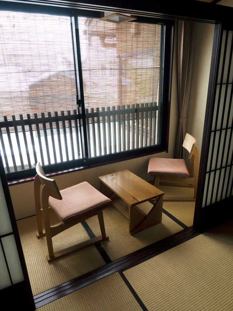 two chairs and table in a sitting nook in front of a window